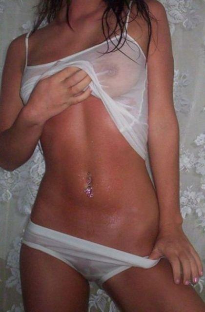 Tanned lady with hurt belly by the piercing infection