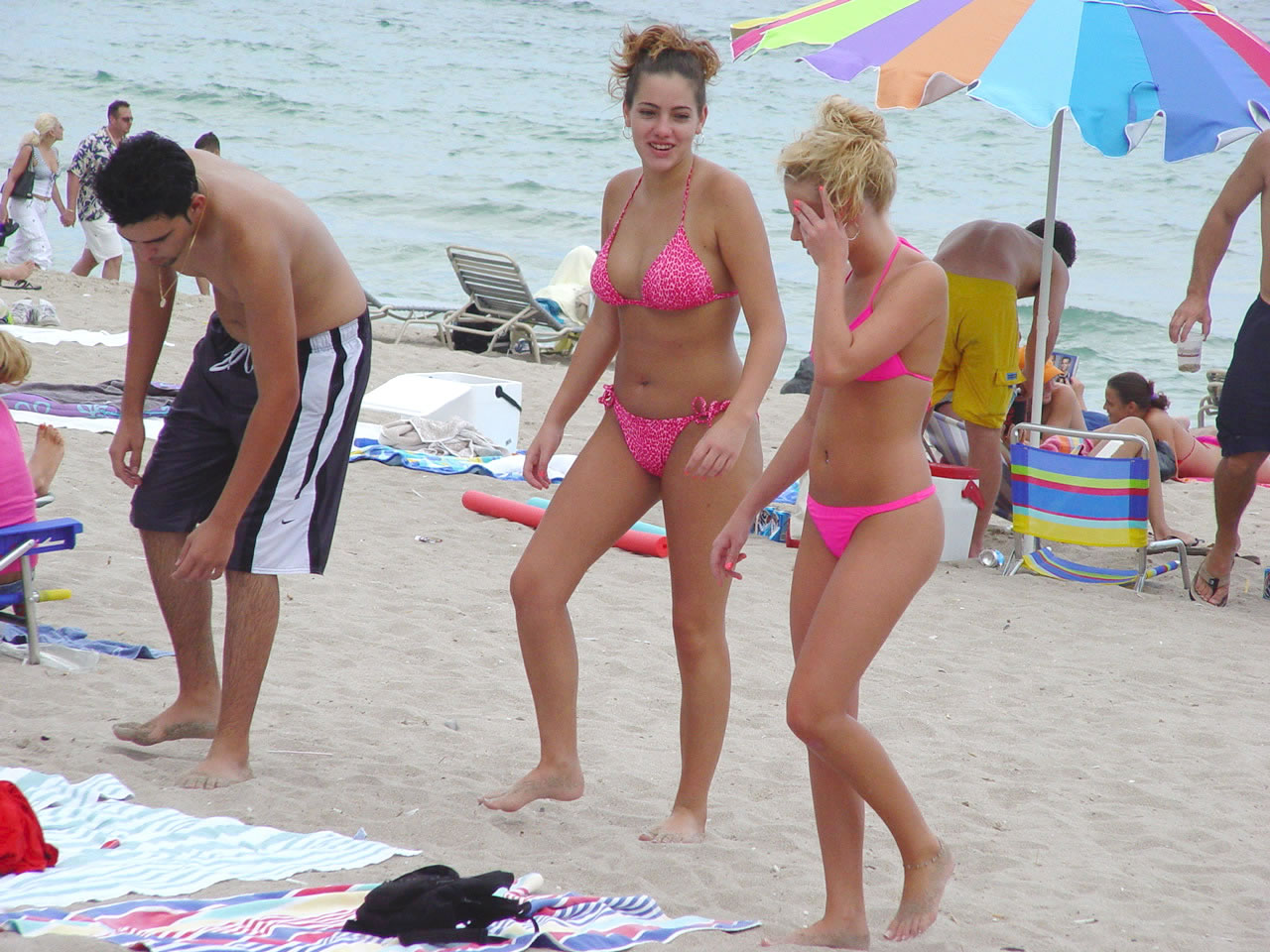 Pink bikini babes walking on hot beach sands photo photo