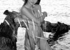 Lusty model in the lake with her clothes off and sexy posture