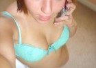 Sweet girl speaking at phone takes a selfie