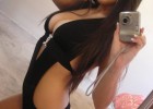 Sweet girl in sexy black suit that dresses her body like a second skin