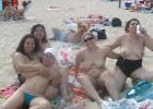 Fat females at the beach with huge bosoms having a beer
